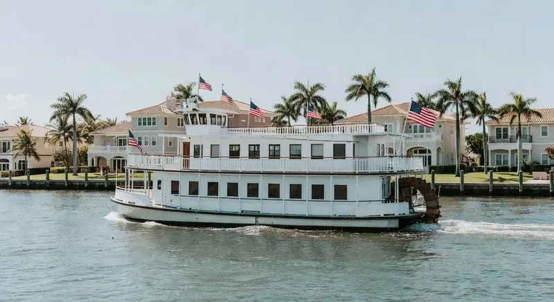 The Carrie B historic paddlewheeler cruising the New River on the Venice of America sightseeing tour in Fort Lauderdale, waterfront mansions and yachts visible on both sides